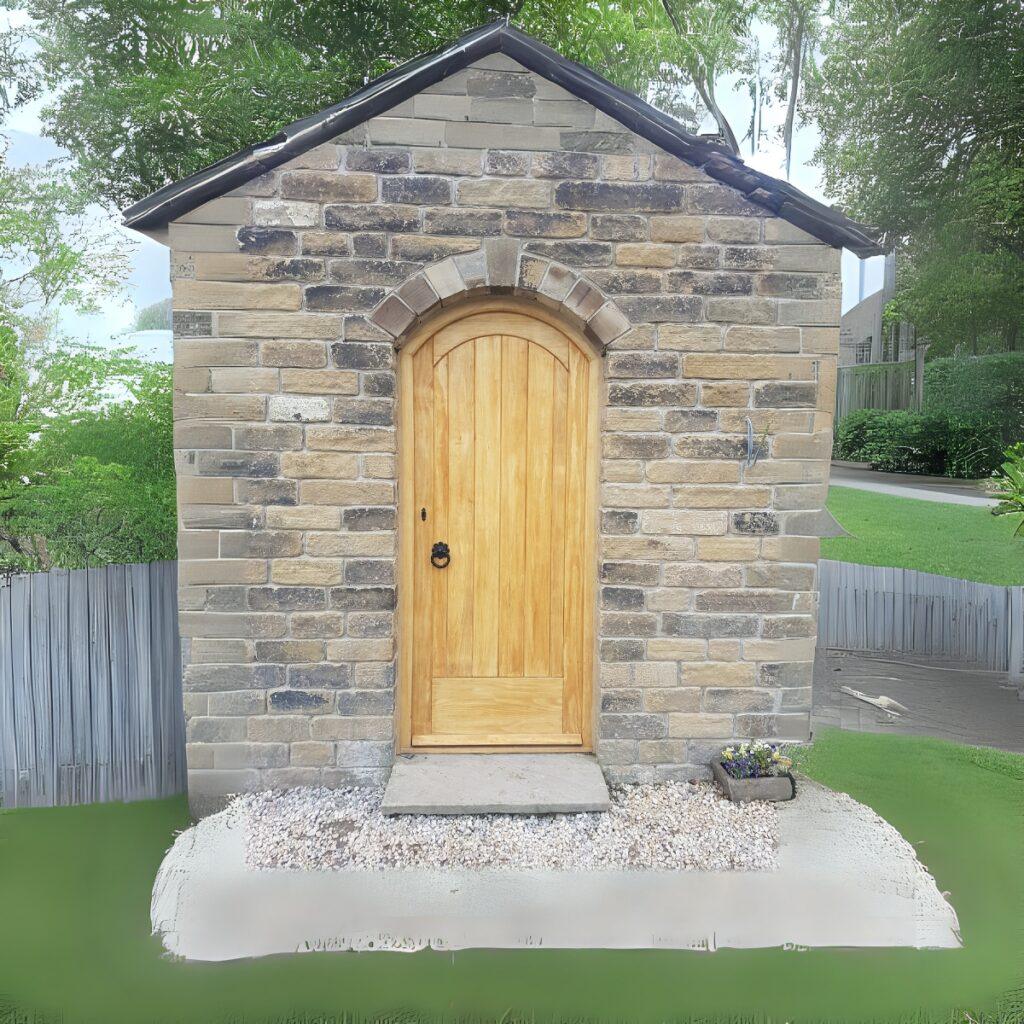 Arched timber door in stone building
