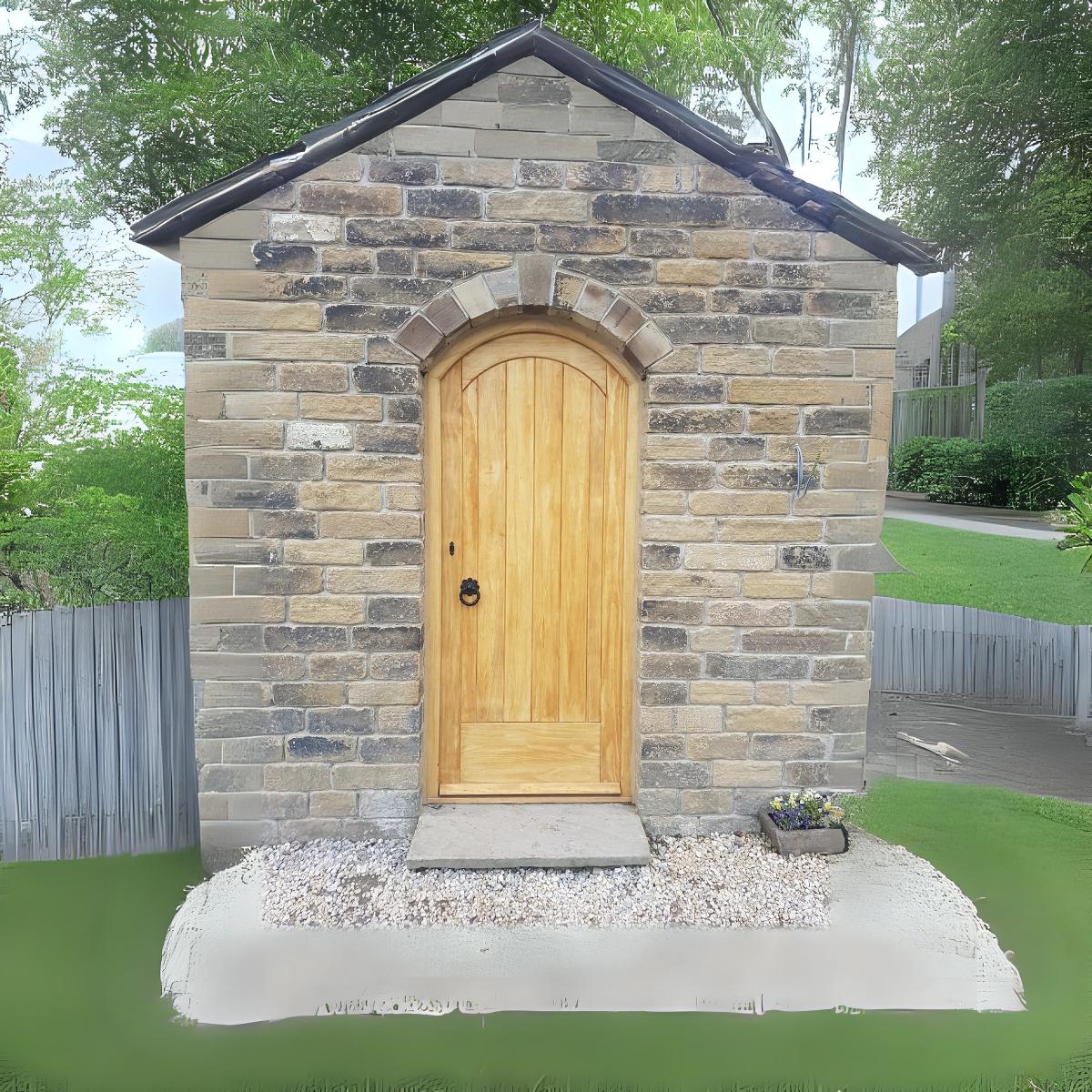 Arched timber door in stone building