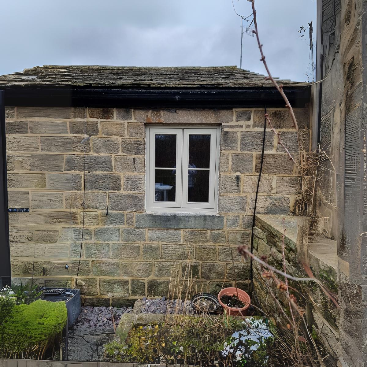 White flush casement window in Yorkshire stone cottage