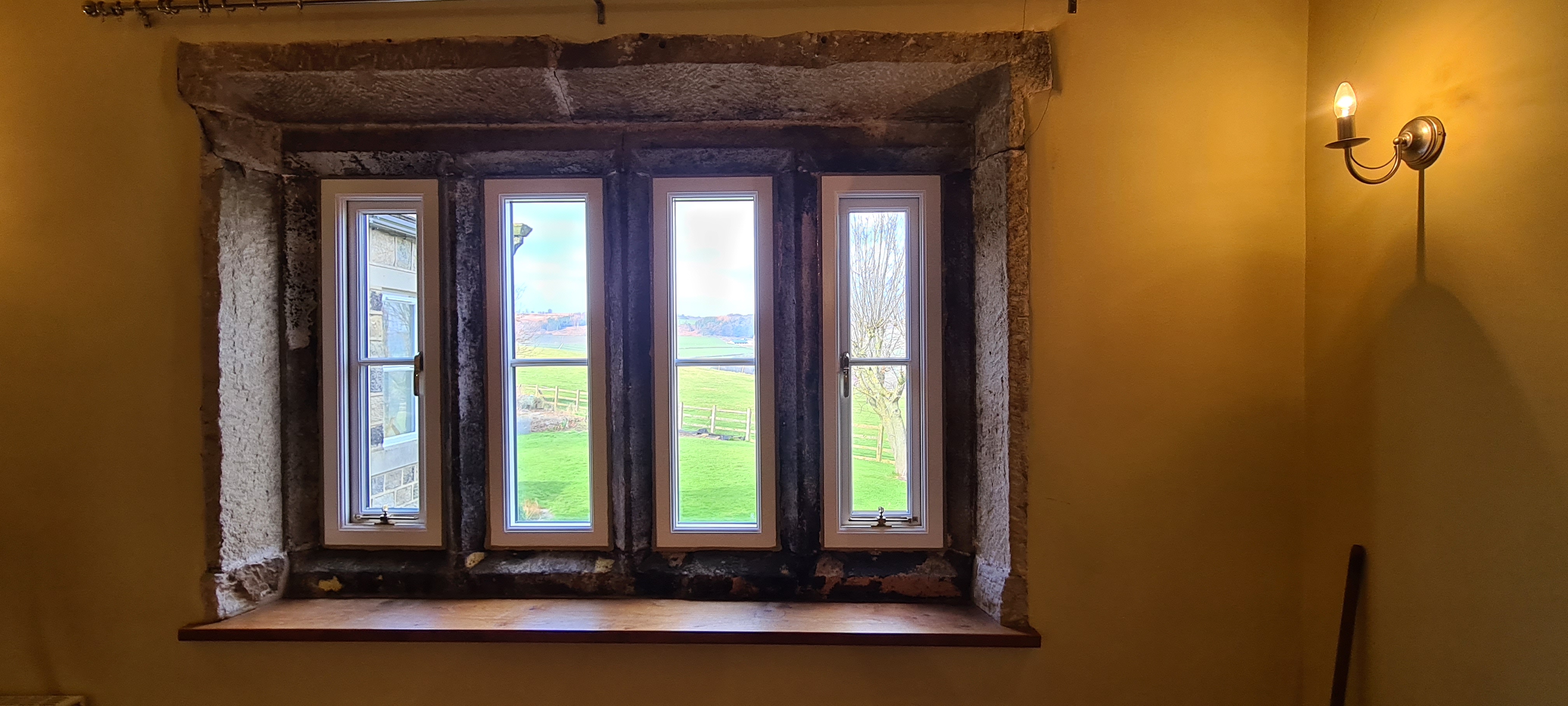 Heritage casement windows installed in deep stone reveal