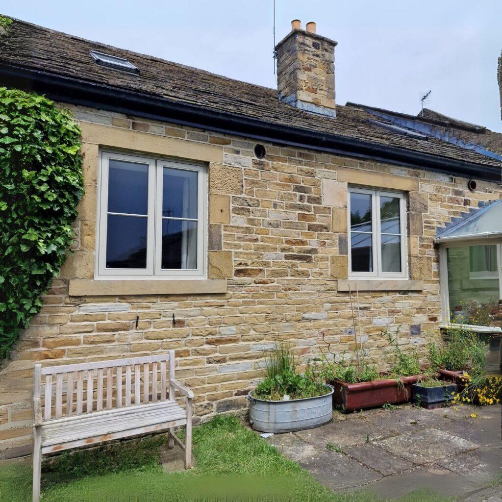 White flush casement window in stone cottage