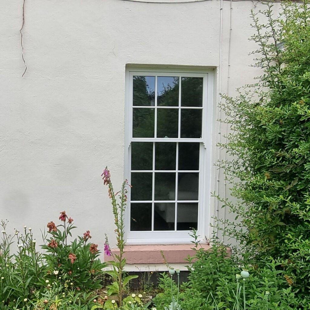 Timber sash windows in a red brick Victorian terrace