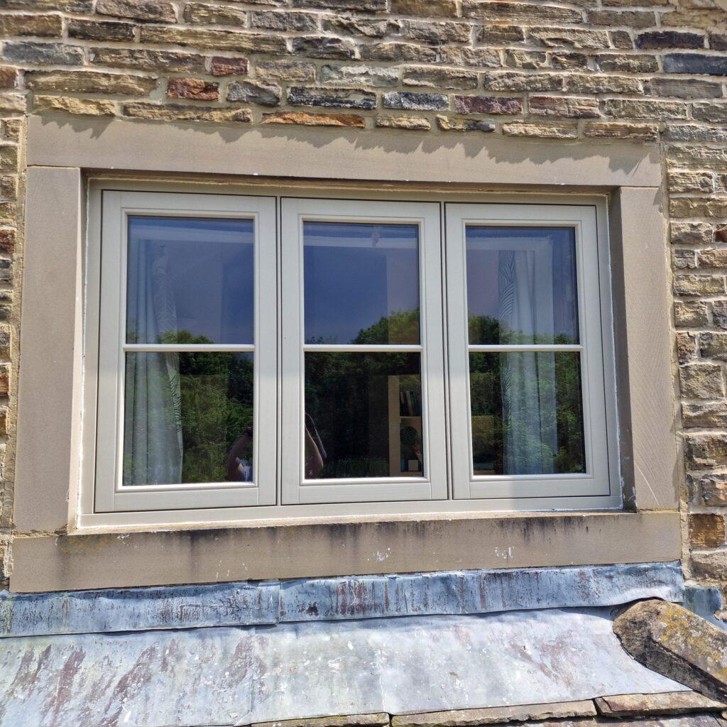 Three-light flush casement window set in stone at Esholt