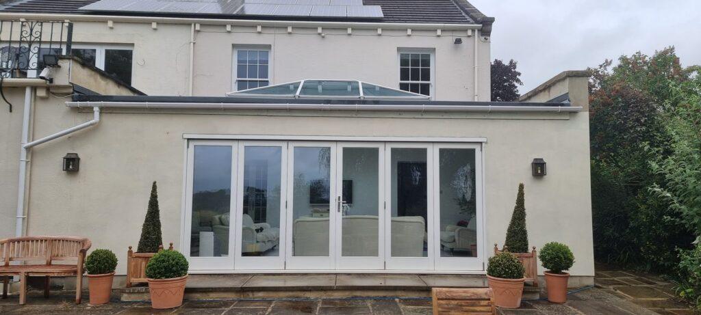 Accoya bifolding doors and roof lantern on a garden room at Huby