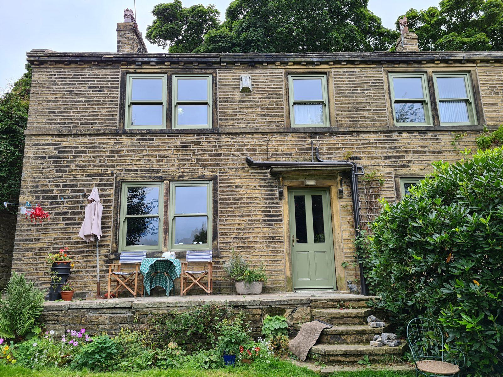 Stone farmhouse at Long Lane, Allerton with sage green timber windows and door