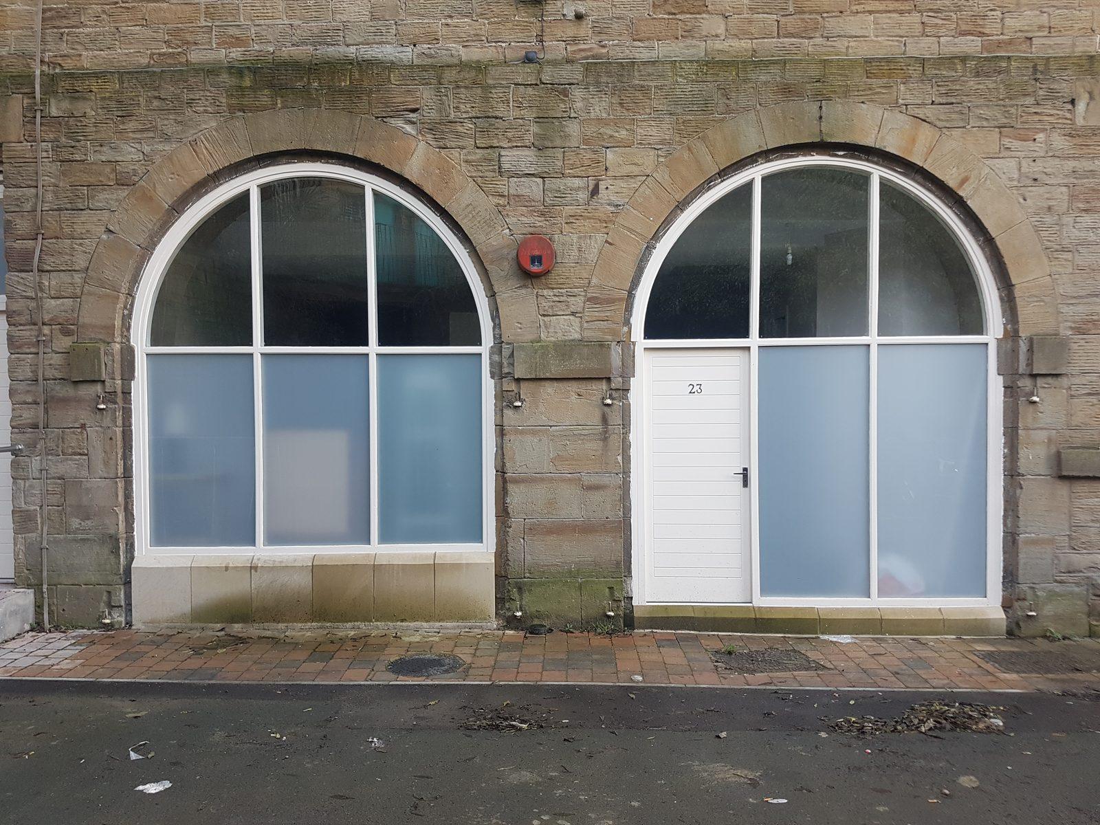 Arched timber window and door set in the former Batley railway station